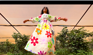 MacBook Air screen showing photo of person in colorful outfit, demonstrating color range and resolution of Liquid Retina display